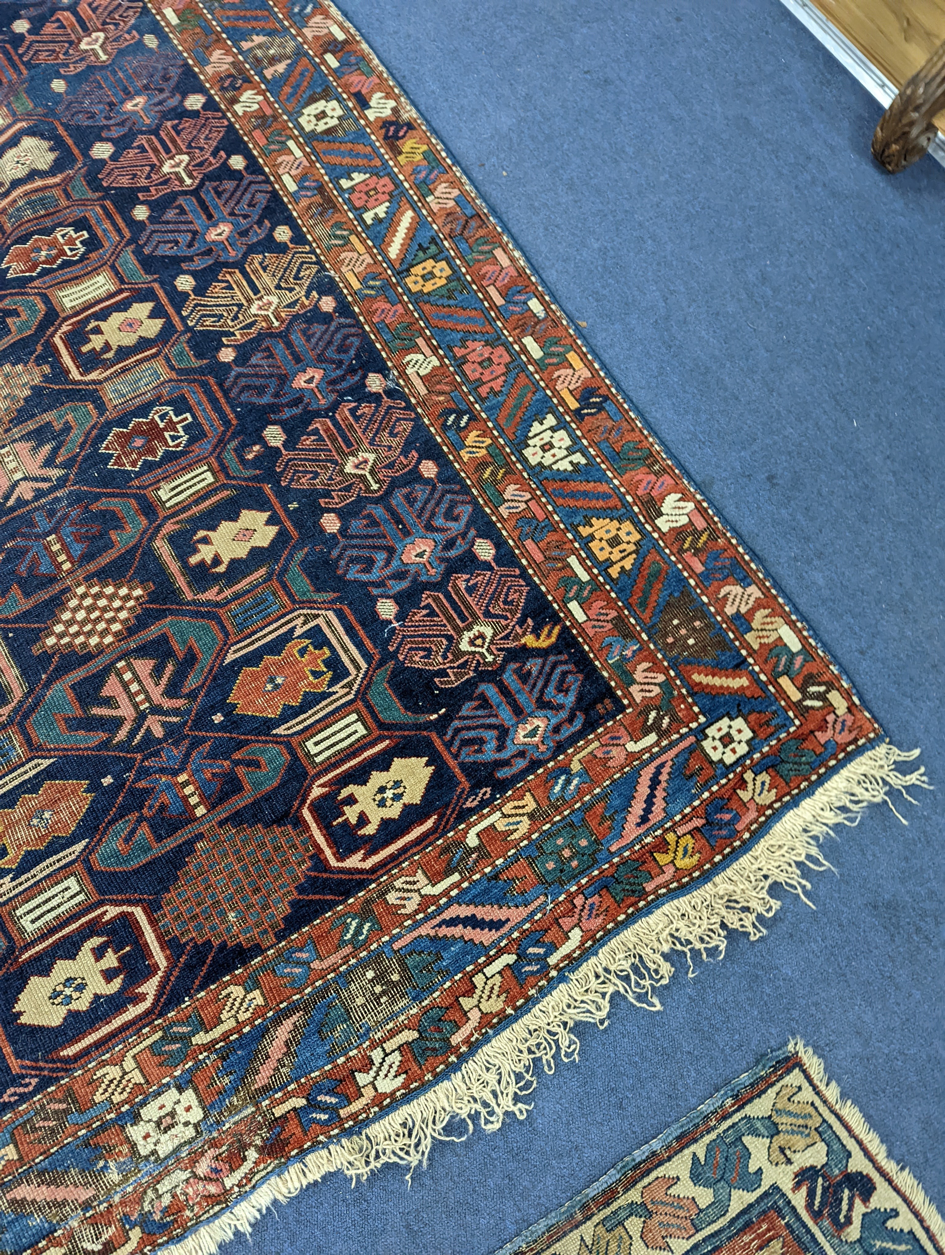 An antique Caucasian blue ground rug, 260 x 130cm